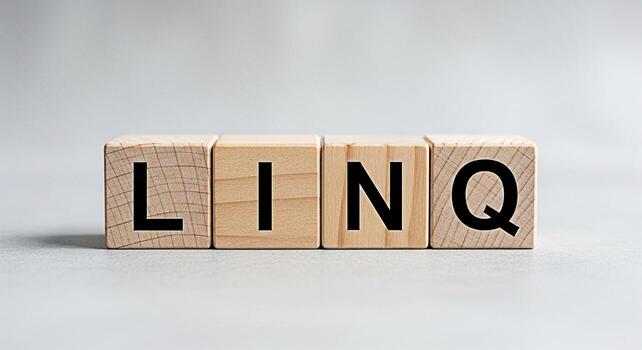 Wooden blocks spelling LINQ on a neutral surface representing data integration and querying in a clean minimalist setting conveying precision and efficiency in data management photo