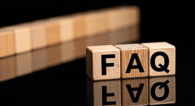 Wooden blocks spelling FAQ displayed on a reflective black surface representing frequently asked questions and information resources for customer support and online assistance creating a helpful and i photo