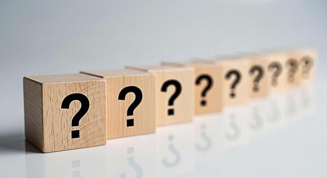 Wooden blocks displaying question marks in a bright studio setting representing uncertainty inquiry and the search for answers evoking curiosity and the need for problemsolving in business and educati photo