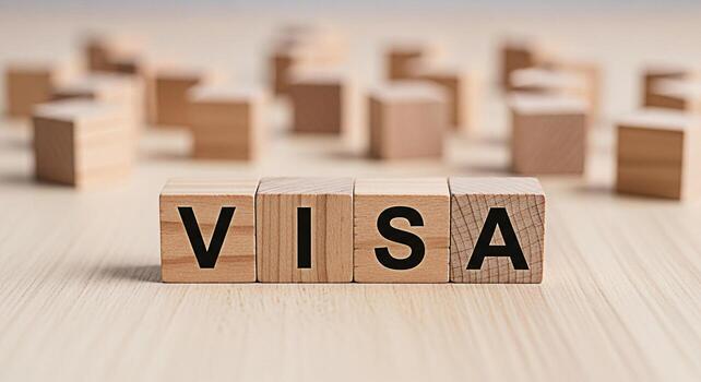 Wooden blocks spelling VISA on a light wooden surface symbolizing international travel and immigration processes creating a sense of opportunity and global connection in a minimalist setting photo