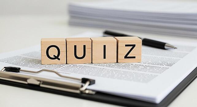 Wooden blocks spelling QUIZ on a clipboard with a pen in a bright office setting representing knowledge assessment and testing promoting learning and education in a professional environment photo