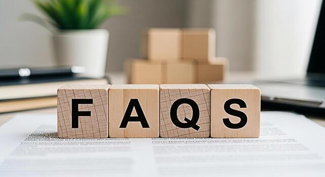 Wooden blocks displaying FAQs on a bright desk representing frequently asked questions and providing answers in a professional and informative setting conveying clarity and helpfulness photo