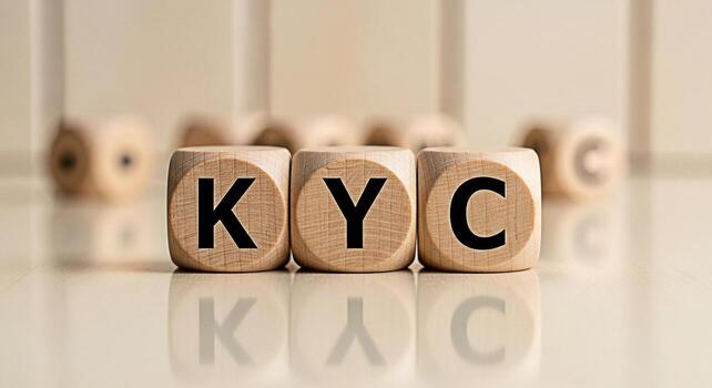 Wooden blocks displaying KYC on a reflective surface representing compliance and identity verification in a financial setting conveying trust and security for banking and regulatory concepts photo