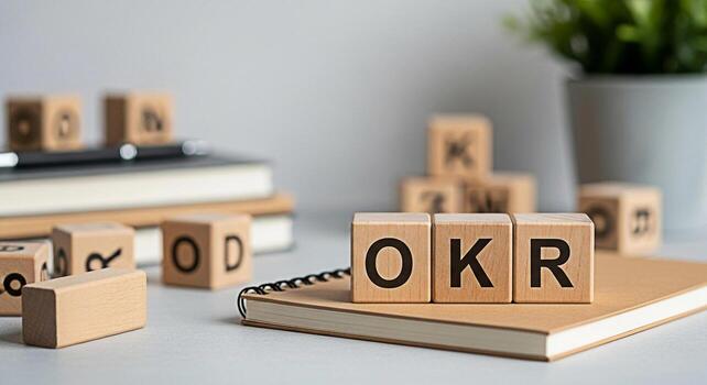 OKR wooden blocks on a notebook in a bright office setting symbolizing Objectives and Key Results promoting a focused and strategic approach to goal setting and achievement in business and project man photo