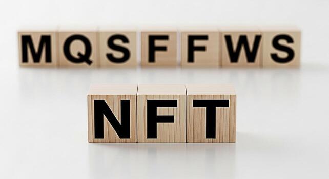 Wooden blocks spelling out NFT on a white surface representing the concept of NonFungible Tokens and digital assets in a clean minimalist setting conveying innovation and modern technology photo