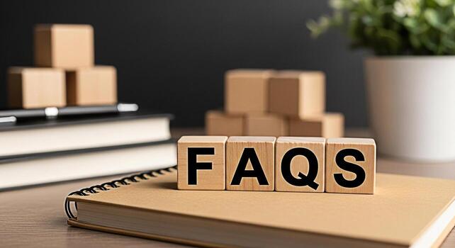 Wooden blocks displaying FAQs on a notebook in a bright office setting representing frequently asked questions and providing helpful information with a focus on customer support and problemsolving photo