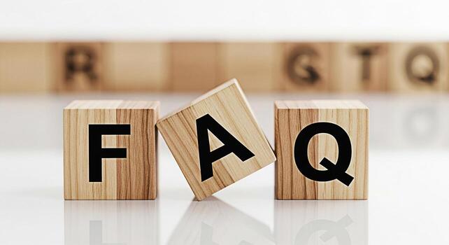 Wooden blocks spelling FAQ resting on a reflective surface conveying a sense of clarity and accessibility in a bright minimalist setting symbolizing customer support and information resources photo