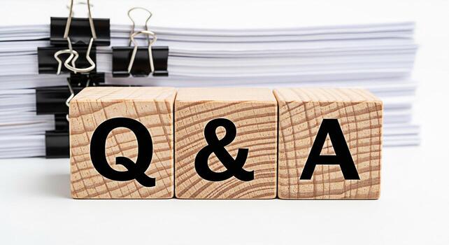 Wooden blocks displaying Q A in a bright studio setting representing questions and answers knowledge sharing and information exchange for business education and customer service concepts photo