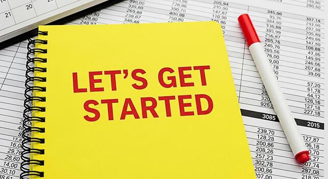 Bright yellow notepad with Lets Get Started text on a financial document symbolizing motivation and new beginnings in a business setting encouraging action and a positive mindset for success photo