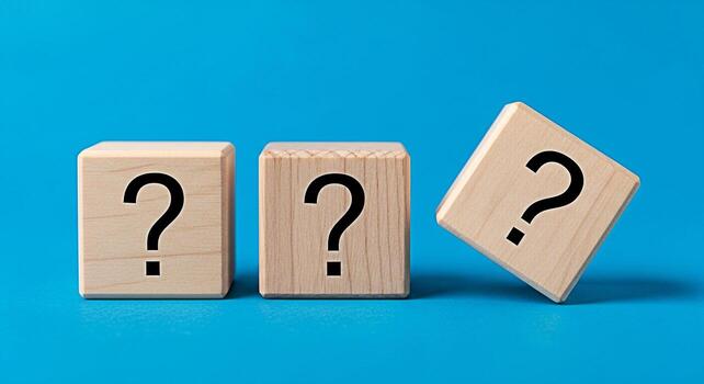 Three wooden cubes displaying question marks on a vibrant blue surface symbolizing uncertainty and the need for answers in business strategy and decisionmaking creating a sense of curiosity and proble photo