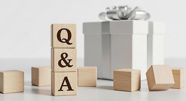 Wooden blocks displaying Q A next to a wrapped gift box on a white surface representing answers support and solutions in a clean and minimalist setting conveying clarity and helpfulness photo