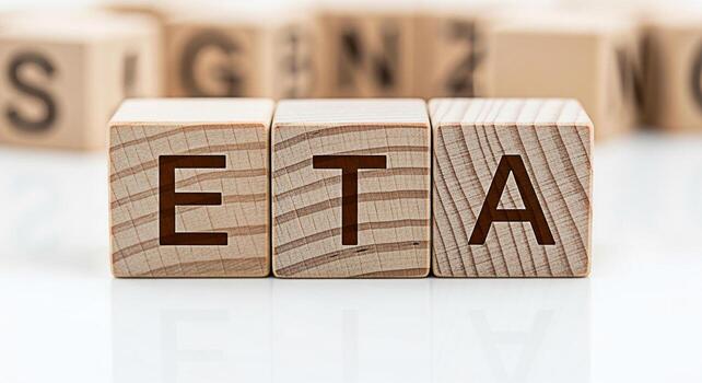 Wooden blocks displaying the letters ETA on a white surface representing Estimated Time of Arrival in a business setting conveying a sense of expectation and planning for project management and logist photo
