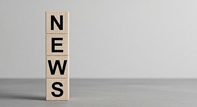Wooden blocks spelling NEWS stacked on a gray surface symbolizing information and current events in a minimalist studio setting conveying a sense of reliability and uptodate knowledge photo