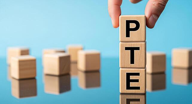 Hand placing a wooden block with the letter P on top of TE blocks against a blue background symbolizing PTE exam preparation educational success and the importance of language proficiency testing photo