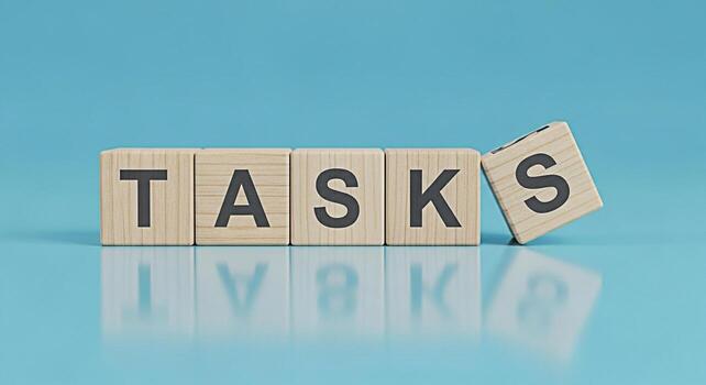 Wooden blocks spelling TASKS on a reflective blue surface symbolizing prioritization and time management in a modern minimalist setting conveying a sense of organization and productivity photo