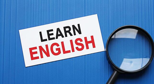 aumentador vaso examinando un tarjeta con el palabras aprender Inglés en un azul texturizado antecedentes representando el concepto de idioma adquisición y educativo oportunidades para global comunicación foto