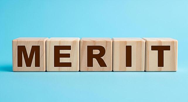 Wooden blocks spelling MERIT on a blue surface representing achievement and success in a clean minimalist setting symbolizing recognition and positive attributes photo