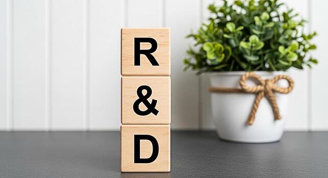 Wooden blocks spelling RD in a bright office environment symbolizing research and development innovation and a commitment to progress and growth in a modern business setting photo