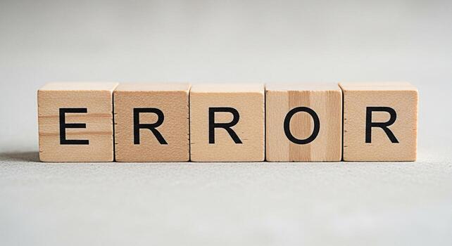 Wooden blocks spelling ERROR on a neutral surface representing a system failure a coding mistake or a general problem conveying a sense of frustration and the need for troubleshooting photo