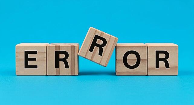 Wooden blocks spelling ERROR on a blue background symbolizing a system failure or programming bug creating a sense of frustration and the need for troubleshooting in a techfocused environment photo