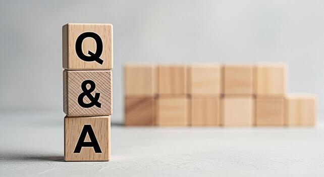 Wooden blocks stacked vertically displaying QA on a neutral surface representing information and knowledge sharing in a minimalist and clean setting symbolizing clarity and understanding photo
