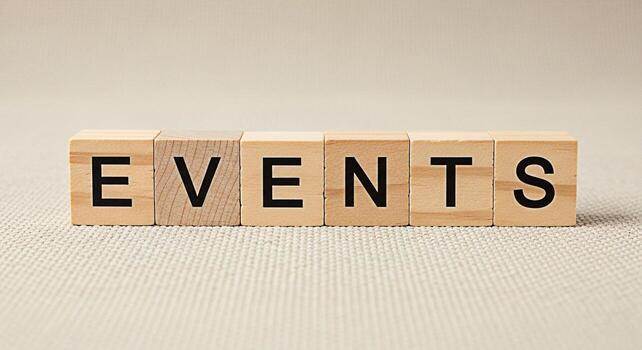 Wooden blocks spelling EVENTS on a textured surface symbolizing upcoming occasions and gatherings creating a sense of anticipation and excitement for planned activities and social engagements photo