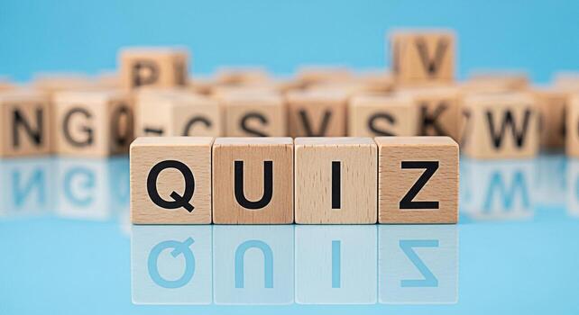 Wooden blocks spelling QUIZ on a reflective blue surface creating a playful and educational atmosphere ideal for online learning platforms and interactive educational content promoting knowledge asses photo