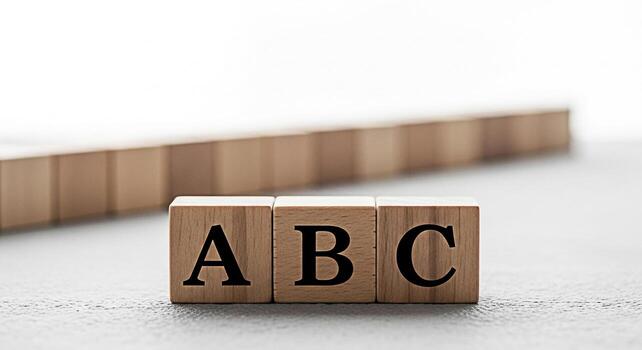Wooden ABC blocks spelling out the alphabet on a gray surface symbolizing early childhood education and learning in a bright minimalist studio environment promoting concepts of knowledge and developme photo