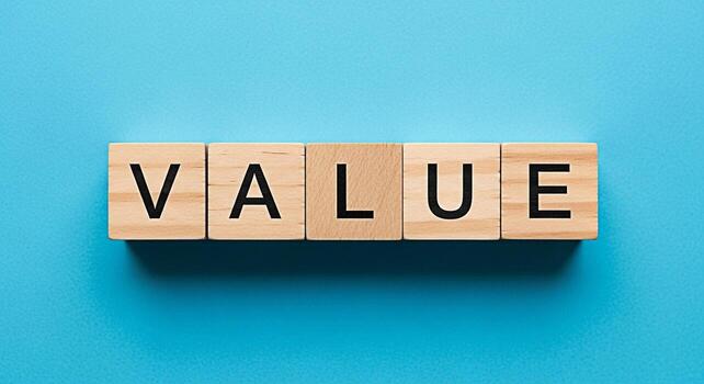 Wooden blocks spelling out VALUE on a vibrant blue background representing the core values and importance of business ethics and financial success creating a sense of trust and reliability photo