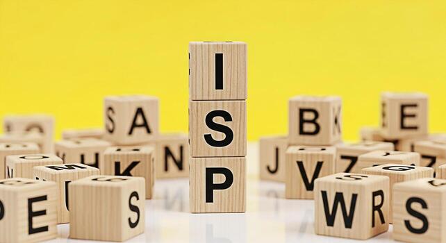 Wooden blocks spelling ISP standing tall amidst scattered alphabet blocks against a vibrant yellow backdrop symbolizing internet service provider connectivity and the digital age with a focus on infor photo