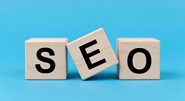 Wooden blocks spelling SEO on a blue background representing search engine optimization strategies and digital marketing techniques for online business growth and improved website ranking photo