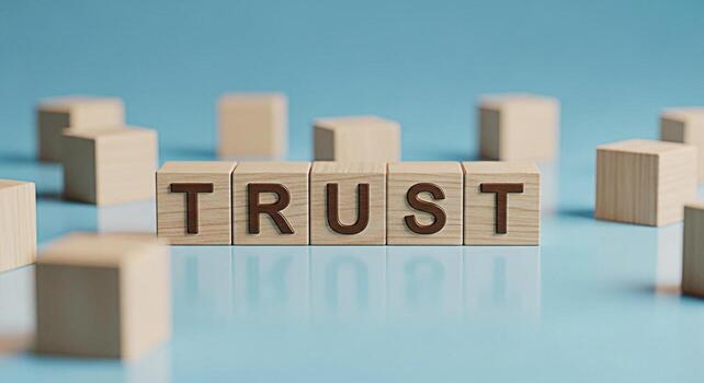 Wooden blocks spelling TRUST on a reflective blue surface symbolizing reliability and confidence in a business environment fostering a sense of security and strong relationships with customers and par photo