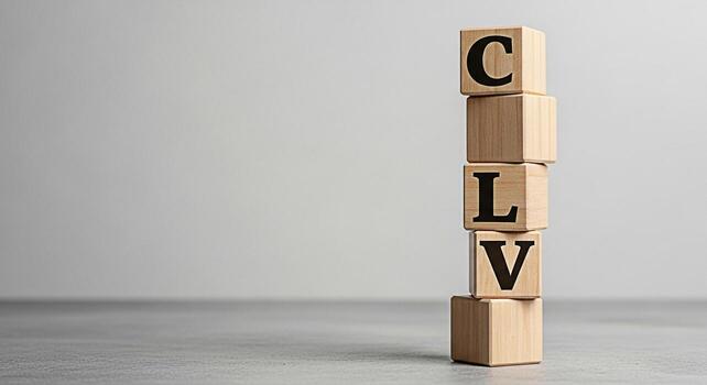 Wooden blocks spelling CLV stacked on a gray surface in a studio setting representing Customer Lifetime Value a key metric for business success and customer relationship management conveying a sense o photo