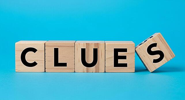 Wooden blocks spelling CLUES on a blue surface suggesting a mystery or puzzle to be solved creating a sense of intrigue and challenge perfect for educational materials or gamerelated content photo