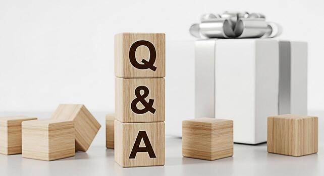 Wooden blocks displaying Q A near a wrapped gift in a bright studio setting symbolizing knowledge support and the anticipation of answers or solutions creating a mood of clarity and helpfulness photo