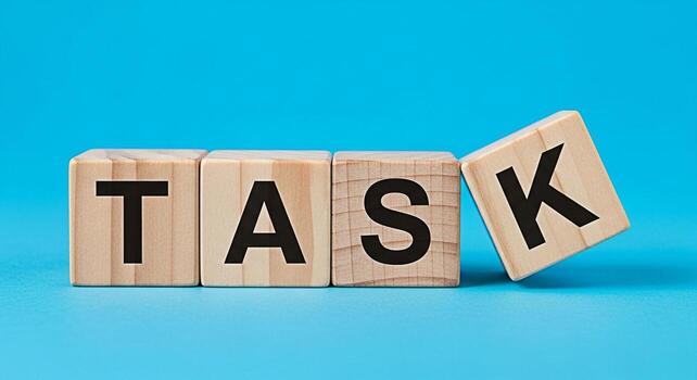 Wooden blocks spelling TASK on a blue background representing a challenge to be completed symbolizing focus productivity and the importance of effective time management in achieving goals photo
