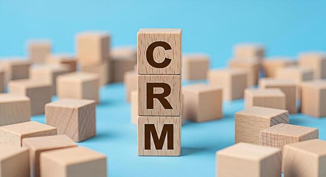 Wooden blocks displaying CRM on a blue background representing customer relationship management a strategic approach to understanding customers and improving business relationships fostering growth an photo
