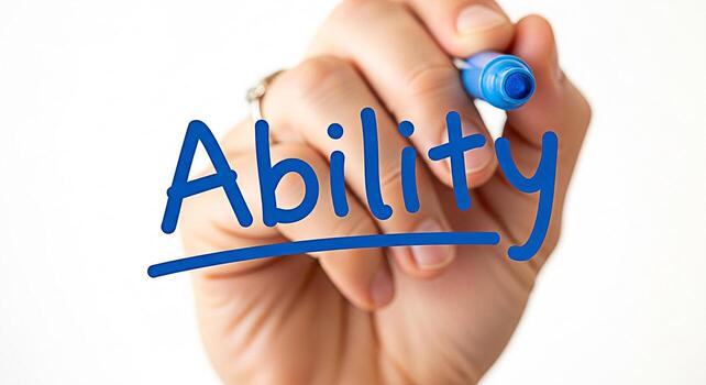 Closeup of a hand writing the word Ability on a clear surface with a blue marker symbolizing skill talent and the potential for success in a bright and optimistic environment photo