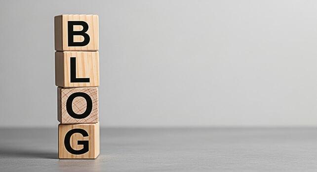 Stack of wooden blocks spelling BLOG on a gray surface symbolizing online content creation and digital marketing strategies in a minimalist studio setting conveying a message of information and connec photo