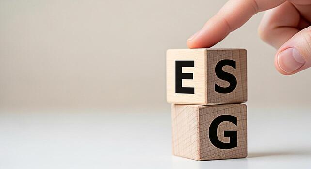 Hand placing wooden blocks with ESG letters on a white surface representing Environmental Social and Governance principles promoting sustainable and responsible business practices for longterm value c photo