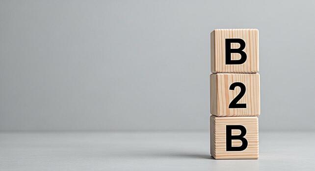 Wooden blocks displaying B2B in a minimalist studio setting symbolizing businesstobusiness relationships and trade conveying a message of partnership commerce and strategic connections in a clean mode photo