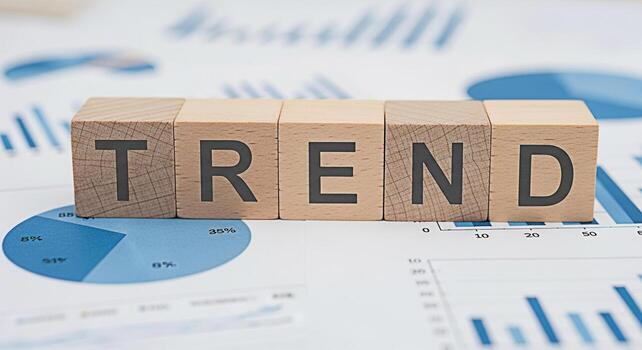 Wooden blocks spelling TREND placed on a financial report with pie charts and bar graphs representing market analysis and the importance of keeping up with current business trends for success and grow photo
