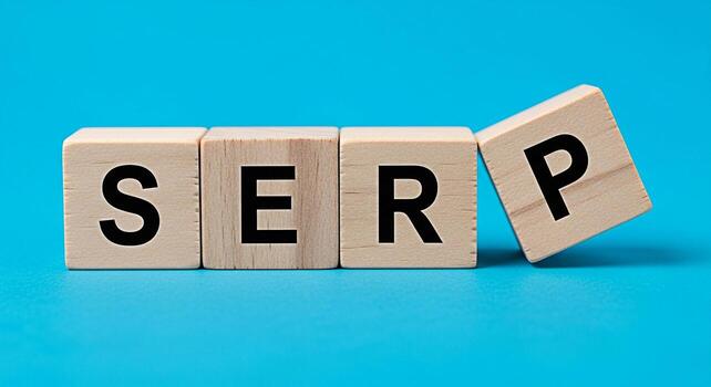 Wooden blocks spelling SERP on a blue background representing Search Engine Results Page optimization and strategy conveying a message of success and visibility in online marketing photo