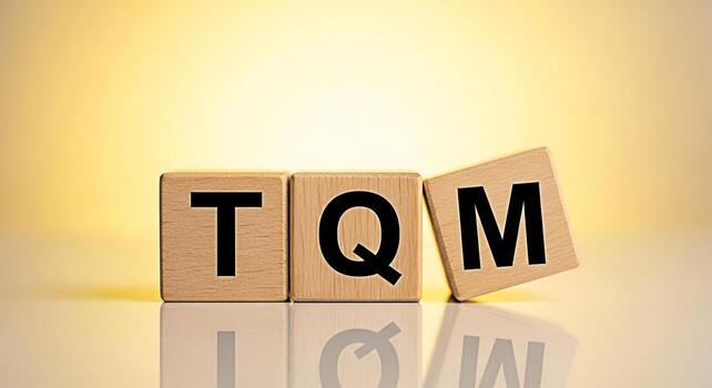Wooden blocks displaying TQM acronym on a reflective surface against a soft yellow background representing Total Quality Management principles and a commitment to continuous improvement and organizati photo