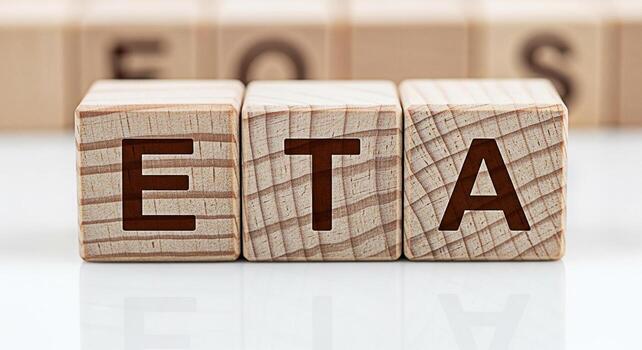 Closeup of wooden blocks spelling out ETA on a white surface representing estimated time of arrival project deadlines and scheduling conveying a sense of anticipation and planning in business and logi photo