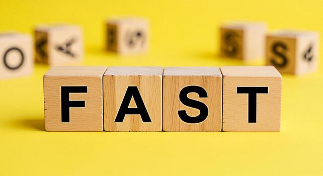 Wooden blocks spelling out FAST on a bright yellow background symbolizing speed and efficiency in a modern minimalist setting conveying a sense of urgency and quick solutions for business and technolo photo