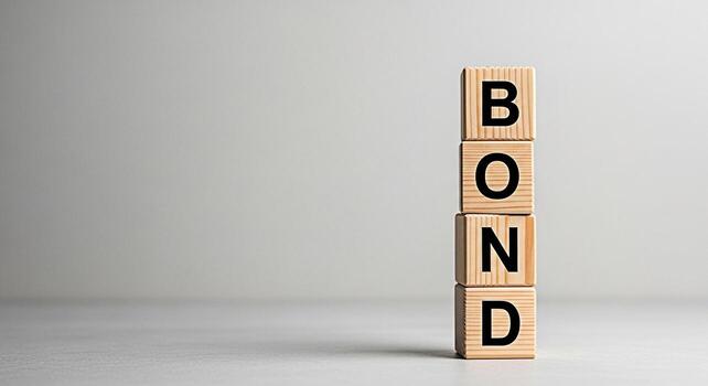 Wooden blocks spelling BOND stacked vertically in a studio setting symbolizing financial security investment and the concept of building strong relationships through trust and commitment photo