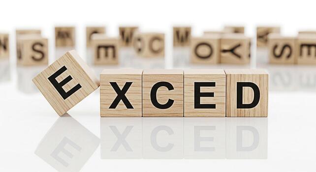 Wooden blocks spelling EXCED on a reflective white surface with one block slightly tilted conveying a sense of exceeding expectations and achieving success in a bright and minimalist setting photo