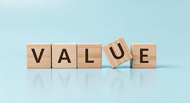 Wooden blocks spelling VALUE on a light blue surface emphasizing the importance of core values in business and personal life creating a sense of stability integrity and trust photo