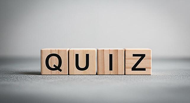 Wooden blocks spelling QUIZ on a gray surface representing knowledge assessment and challenge creating an atmosphere of learning and competition in an educational or corporate setting photo